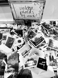 a black and white photo of old photos on a table