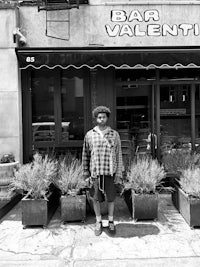 a man standing in front of a bar valentini